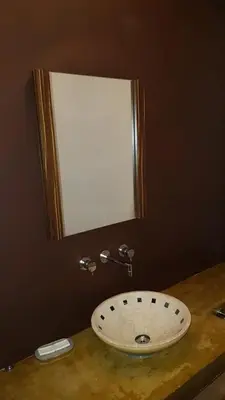 a bathroom sink with a mirror on the wall at LA CASITA in Villa Carlos Paz