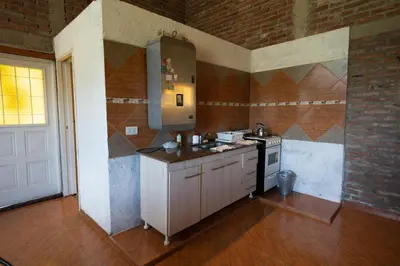 a kitchen with a sink and a stove in a room at Chalet y Cabaña de montaña Esmeralda in Villa del Dique
