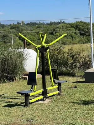 a large yellow windmill sitting on top of a field at Complejo de Cabañas Los 2 Soles 9 in Los Reartes
