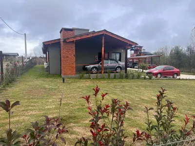 a small house with a car parked outside of it at Complejo de Cabañas Los 2 Soles 9 in Los Reartes