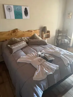 a bedroom with a bed with a towel on it at Complejo de Cabañas Los 2 Soles 9 in Los Reartes