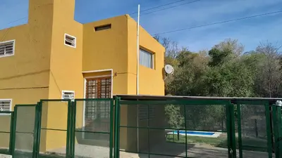 a house with a glass door in front of a building at El Rinconcito de la Selva in La Calera