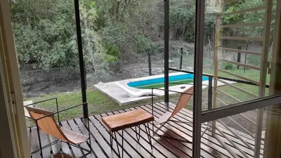 a balcony with a view of a swimming pool at El Rinconcito de la Selva in La Calera
