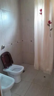 a bathroom with a toilet and a sink at El Rinconcito de la Selva in La Calera