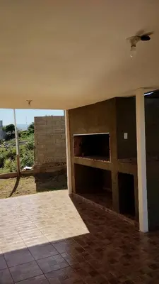 an empty room with a fireplace in a house at El Roble, casa de sierra in Estancia Vieja