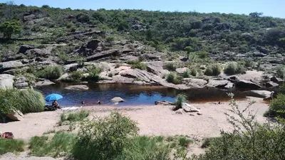 a group of people swimming in a pool of water at El Roble, casa de sierra in Estancia Vieja