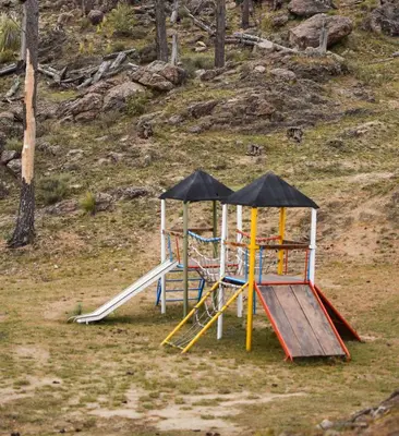 a group of playground equipment with an umbrella at Ayllupelli in Villa Berna