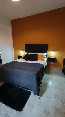 a bedroom with a large bed in a room at Suites Del Centro in Santa Rosa de Calamuchita