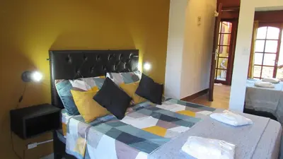 a bedroom with a large bed in a room at Suites Del Centro in Santa Rosa de Calamuchita