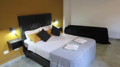 a bedroom with a large bed with two towels on it at Suites Del Centro in Santa Rosa de Calamuchita