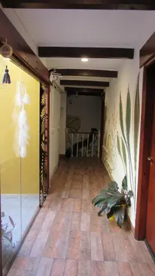 a hallway with a room with a hard wood floor at Suites Del Centro in Santa Rosa de Calamuchita