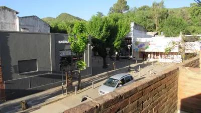 a car parked on a street in a city at Suites Del Centro in Santa Rosa de Calamuchita