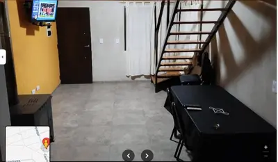a staircase in a room with a table and a television at 