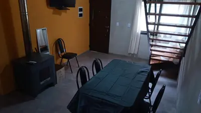 a dining room with a table and chairs and a stove at 