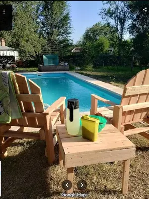 two chairs and a table next to a swimming pool at 