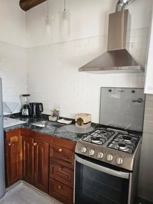 a kitchen with a stove and a counter top at Raíces serranas in Villa de Las Rosas