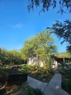 a house with a garden and a walkway at Raíces serranas in Villa de Las Rosas