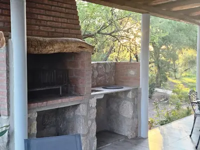a patio with a brick oven on a patio at Raíces serranas in Villa de Las Rosas