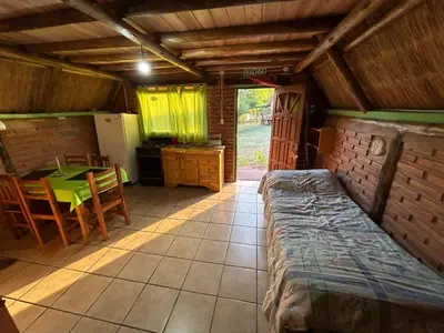 a room with a table and a kitchen with a dining room at baja in Villa Carlos Paz