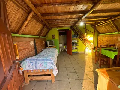 a bedroom with a bed and a table in a room at baja in Villa Carlos Paz