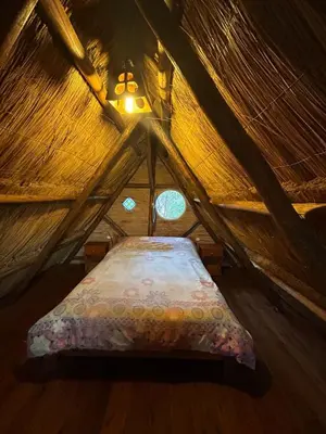 a bed in a yurt with a window at baja in Villa Carlos Paz