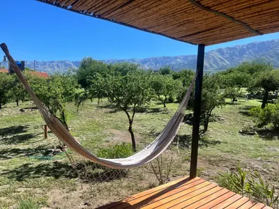a hammock on a porch with a view of a field at Flor Silvestre in Carpintería