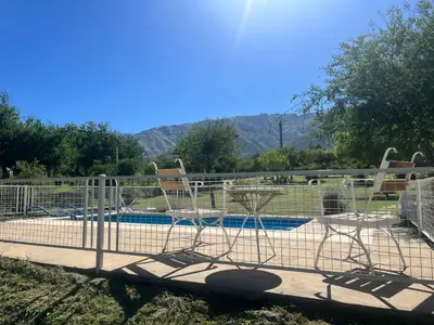 two chairs sitting in front of a swimming pool at Flor Silvestre in Carpintería