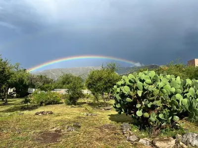a rainbow in the sky over a cactus at Flor Silvestre in Carpintería