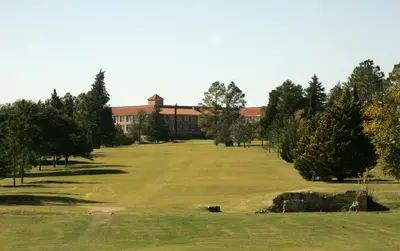 a view of a golf course with a building at San Miguel Plaza Hotel All Inclusive in Villa San Miguel