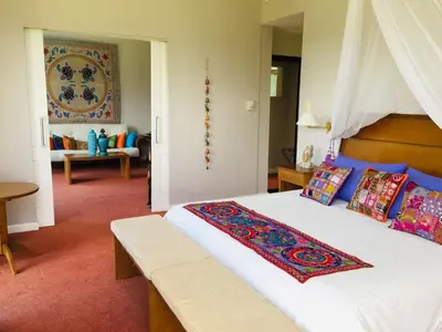 a bedroom with a large bed with a wooden headboard at San Miguel Plaza Hotel All Inclusive in Villa San Miguel
