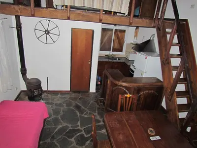 a room with a bunk bed and a desk and a ladder at Cabañas de Montaña San Miguel in Cortaderas