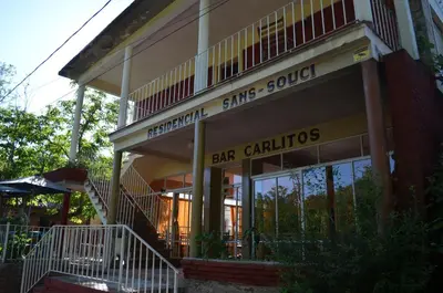 a building with a sign that reads bar grills at Hosteria Sans Souci in Tanti
