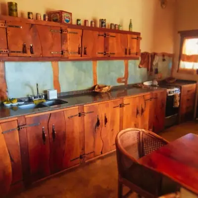 a kitchen with wooden cabinets and a counter top at La Calandria in Los Hornillos