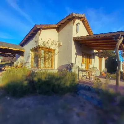 a house with a table in front of it at La Calandria in Los Hornillos