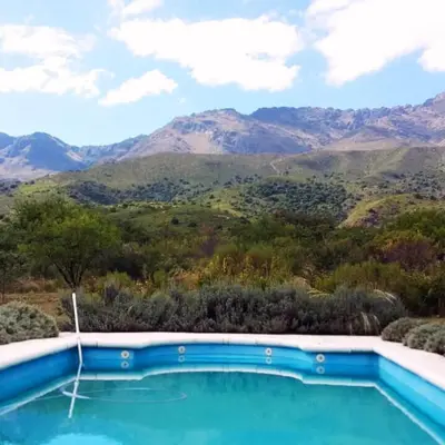 a swimming pool with mountains in the background at La Calandria in Los Hornillos