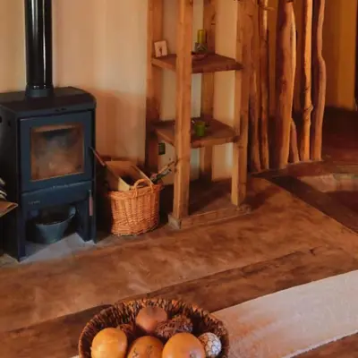 a basket of fruit in a room with a stove at La Calandria in Los Hornillos