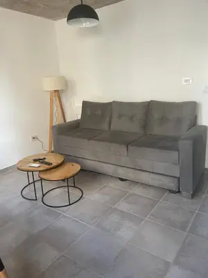 a living room with a gray couch and a table at DEPARTAMENTO Guemes a mts de Nva Córdoba y centro Terraza y pileta! in Cordoba