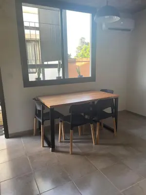 a wooden table with chairs and a large mirror at DEPARTAMENTO Guemes a mts de Nva Córdoba y centro Terraza y pileta! in Cordoba