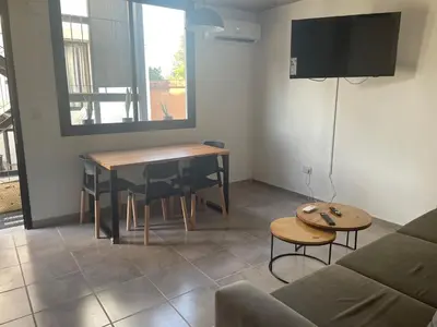 a living room with a table and a couch at DEPARTAMENTO Guemes a mts de Nva Córdoba y centro Terraza y pileta! in Cordoba
