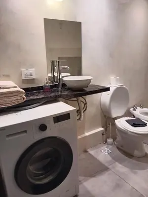 a bathroom with a washing machine and a sink at Hermoso departamento a metros del centro de la ciudad !! in Cordoba