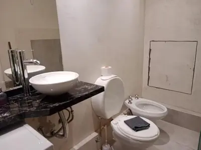a white bathroom with a sink and a toilet at Hermoso departamento a metros del centro de la ciudad !! in Cordoba
