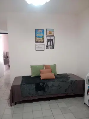 a bedroom with a bed with green and orange pillows at Hermoso departamento a metros del centro de la ciudad !! in Cordoba