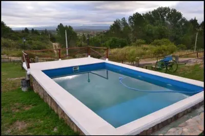a large swimming pool in a yard at Estancia Charo in Villa Carlos Paz