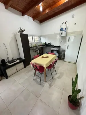 a kitchen with a table and chairs in a room at Estancia Charo in Villa Carlos Paz