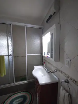 a bathroom with a sink and a mirror and a shower at Gracias Viejo in Merlo