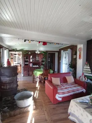 a living room with a red couch and a fireplace at Gracias Viejo in Merlo