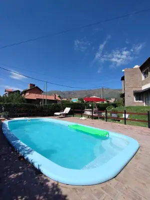 a large blue swimming pool in a yard at Gracias Viejo in Merlo