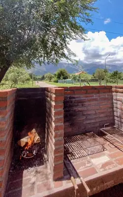 a brick oven with a fire in it at Gracias Viejo in Merlo