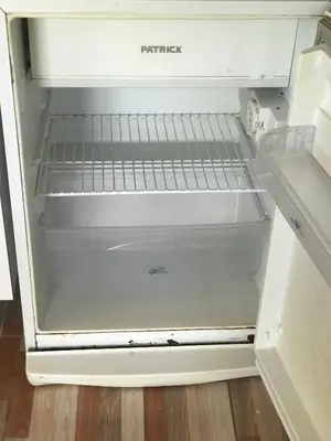 an empty refrigerator with its door open in a kitchen at El CAMPITO in La Ramada