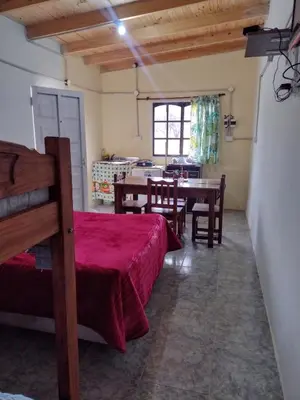 a room with a table and chairs and a dining room at El CAMPITO in La Ramada